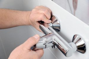 plumber installing shower valve